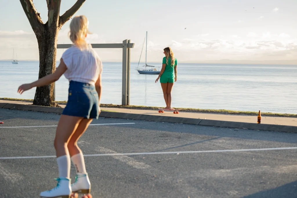 Woman wearing rollerskates in carpark.